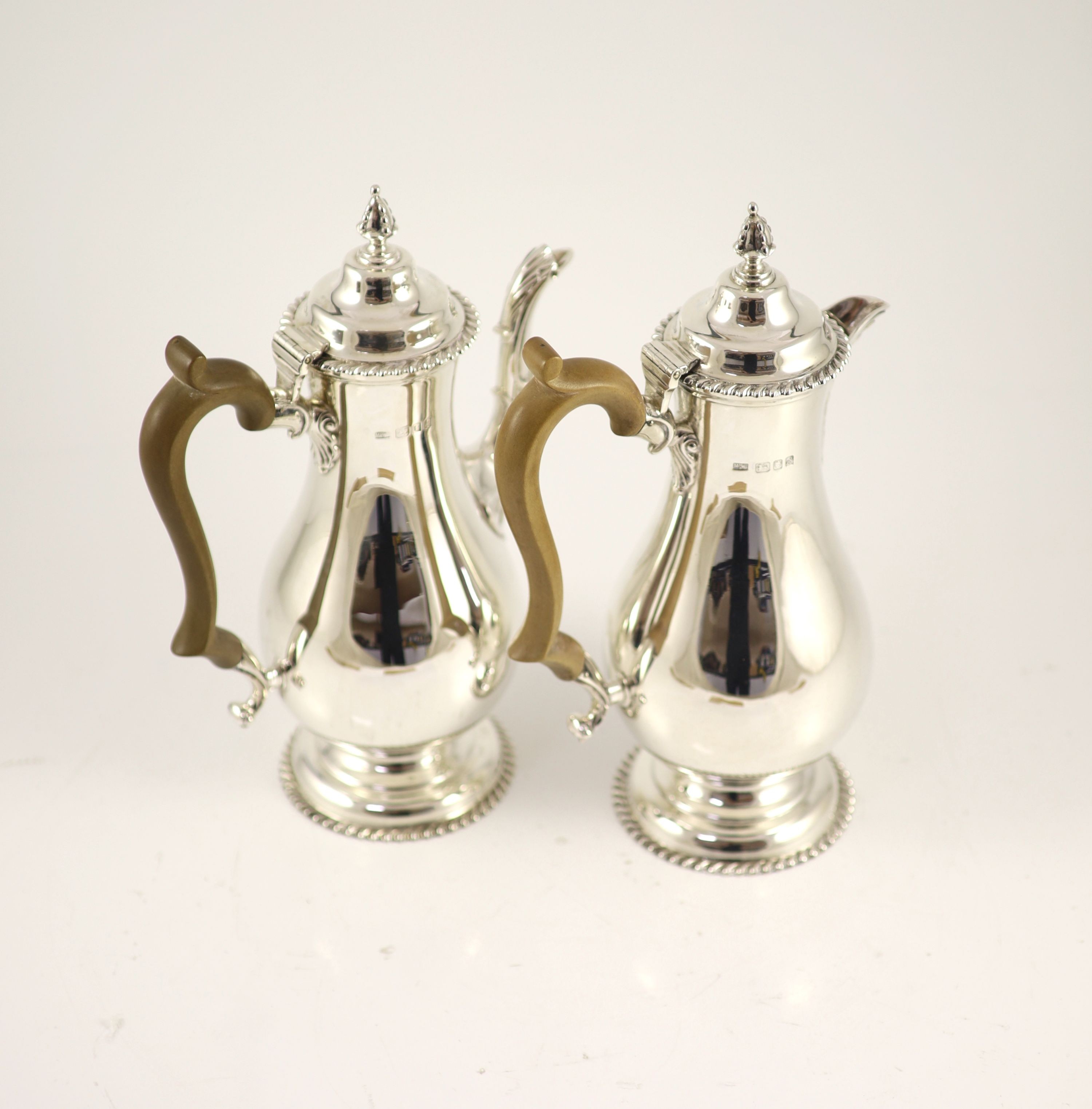 A Mappin & Webb 18th century style silver coffee pot with wood handle and matching hot water jug,